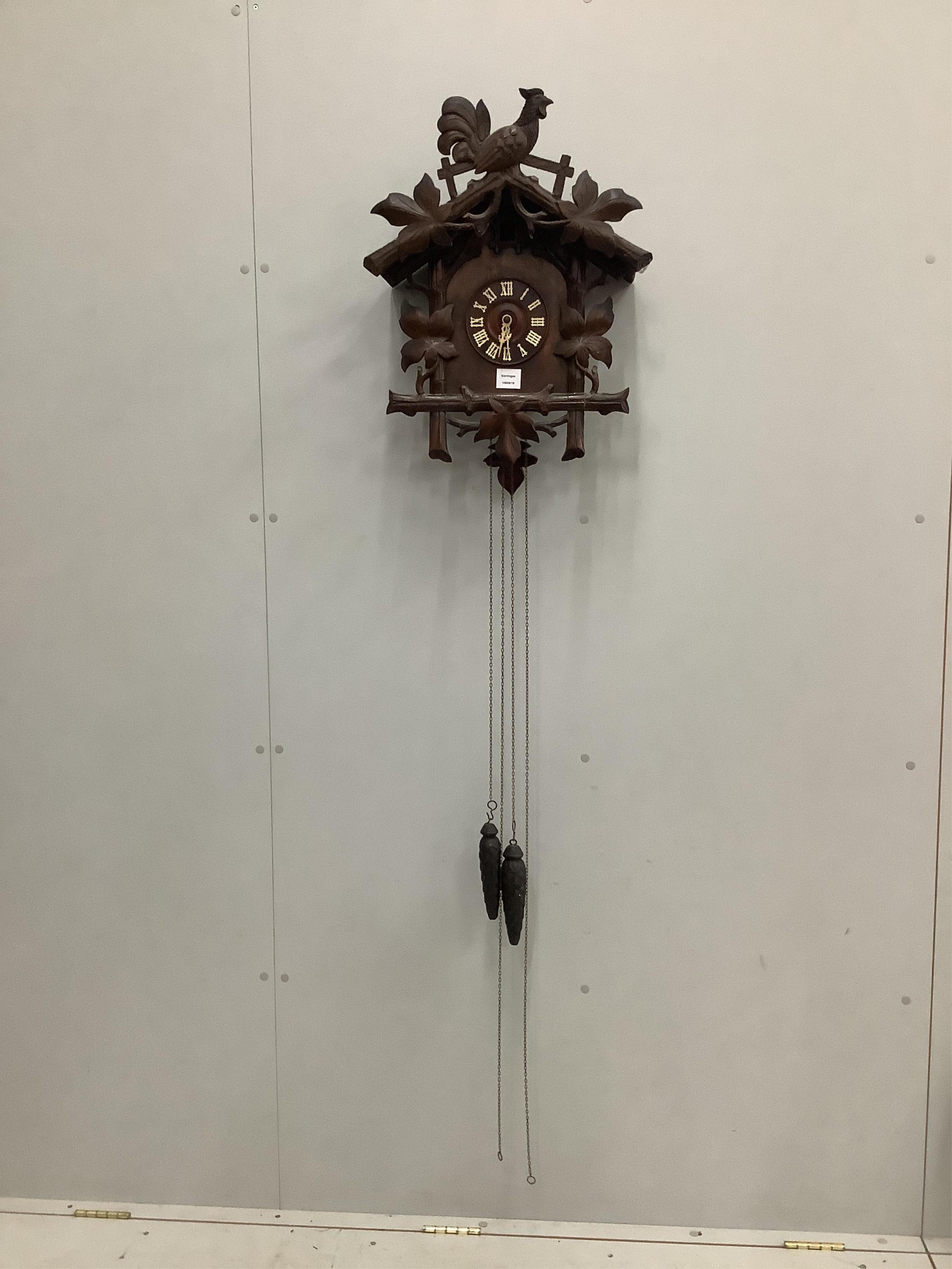 A Black Forest carved cuckoo clock, height 58cm. Condition - fair